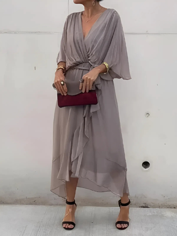 Full-length shot of a women's flowy V-neck belted maxi dress, an elegant long summer style essential.