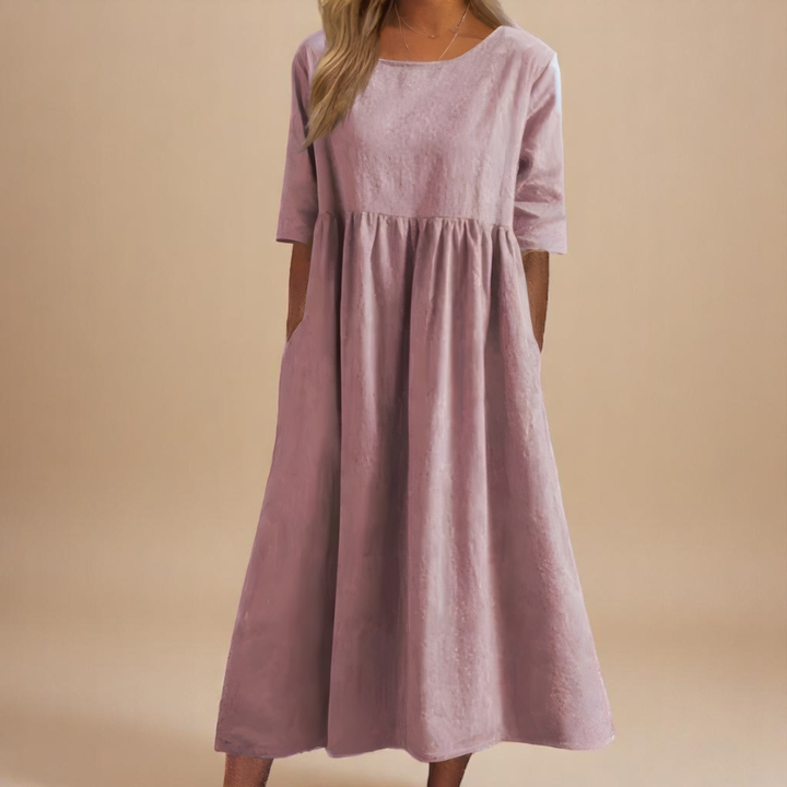 Relaxed fit women's midi dress, half-sleeve, with a gathered waist and practical pockets for casual wear.