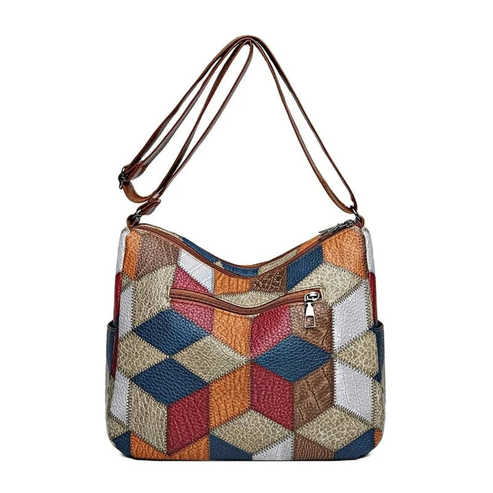 Modern geometric patchwork vegan leather crossbody bag for women, blending style and functionality.