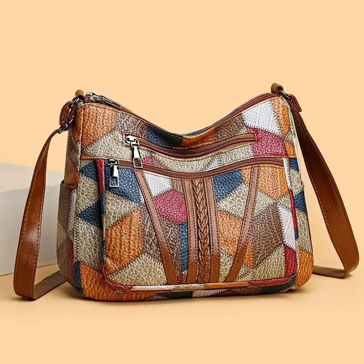 Versatile geometric patchwork vegan leather crossbody bag for women, ideal for everyday use.