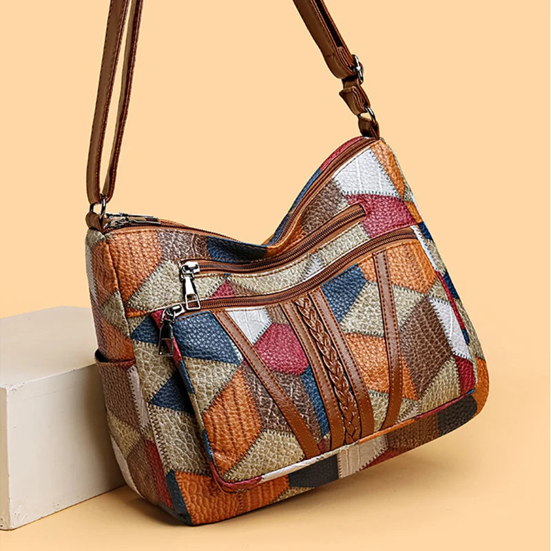 Trendy women's geometric patchwork vegan leather handbag, a chic shoulder or crossbody bag.