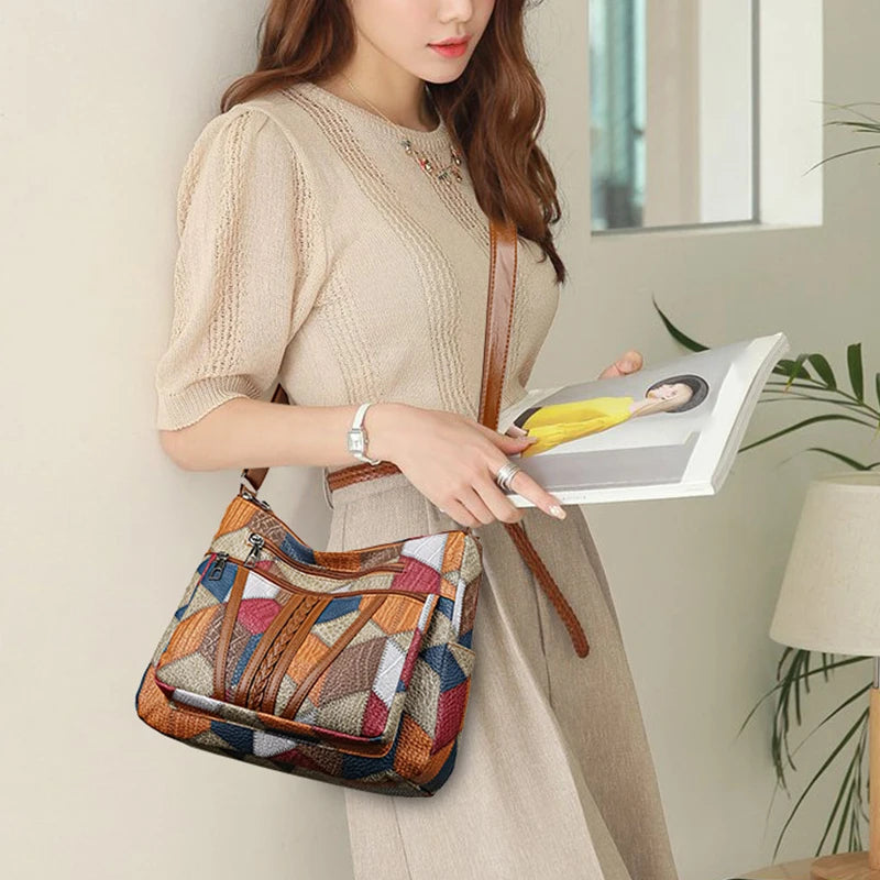 Front view of a women's geometric patchwork vegan leather handbag, a stylish and practical accessory.