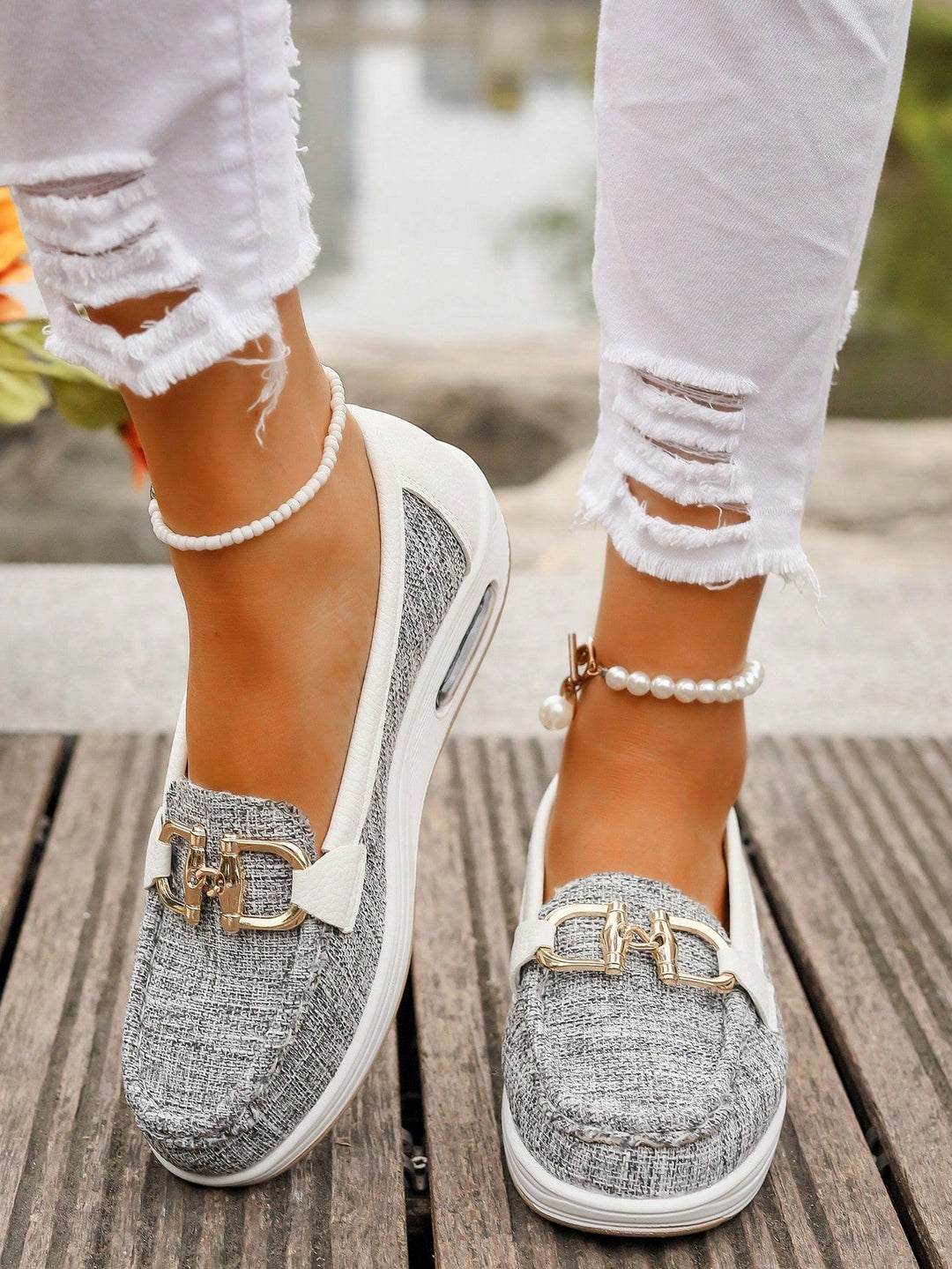 Modern women's gold buckle comfort loafers. Slip-on style for easy everyday wear, suitable for casual or work.