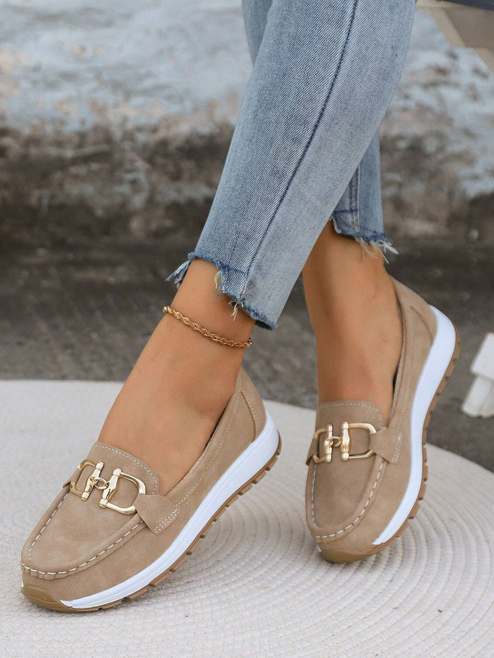 Elegant women's gold buckle slip-on loafers. Comfortable and versatile footwear for work or casual fashion.