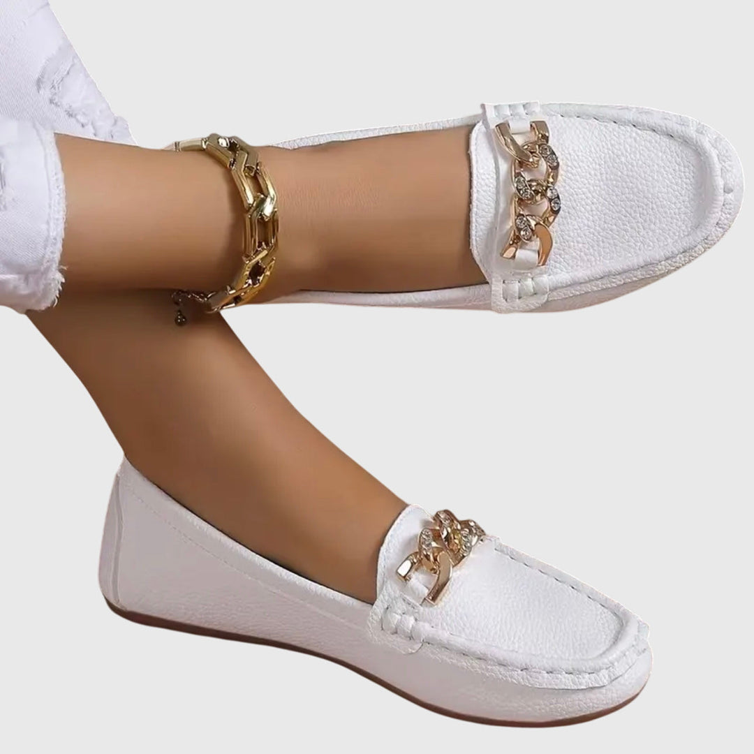 Women's gold-chain wedge loafers, elegant slip-on footwear.