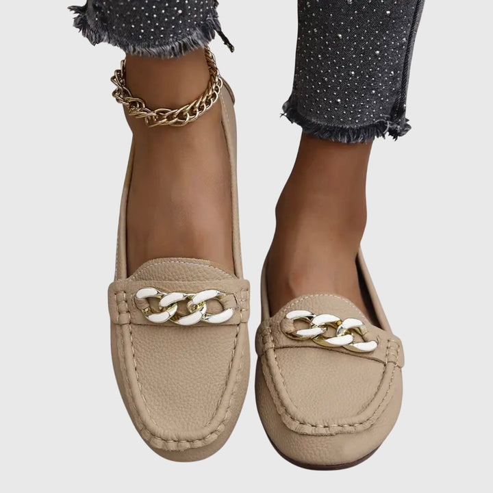 Chic women's slip-on loafers with a gold chain and comfortable wedge.