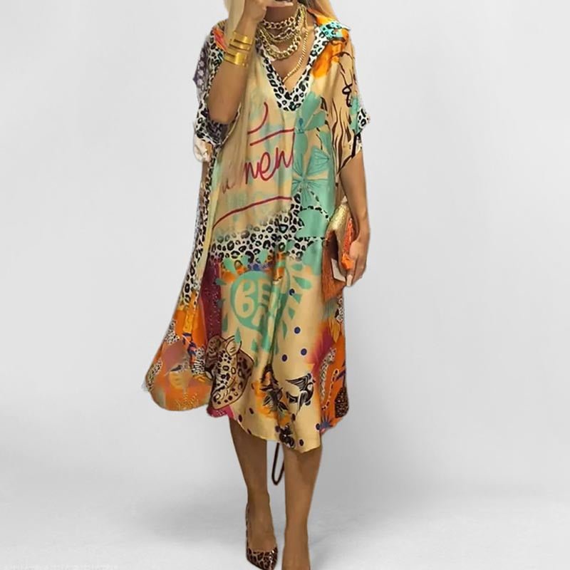 Women's graphic print tunic swing dress with V-neck, short sleeves, and relaxed fit. Perfect for summer casual wear.