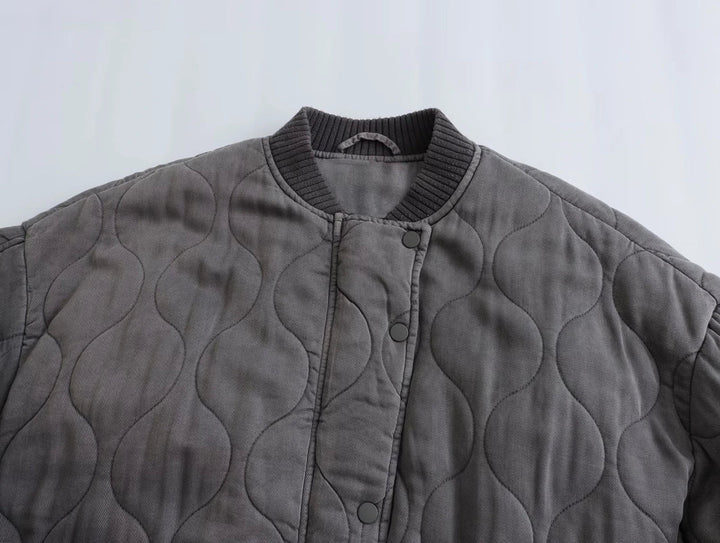 Fashionable women's gray quilted bomber jacket, a chic everyday outerwear essential for stylish fall looks.