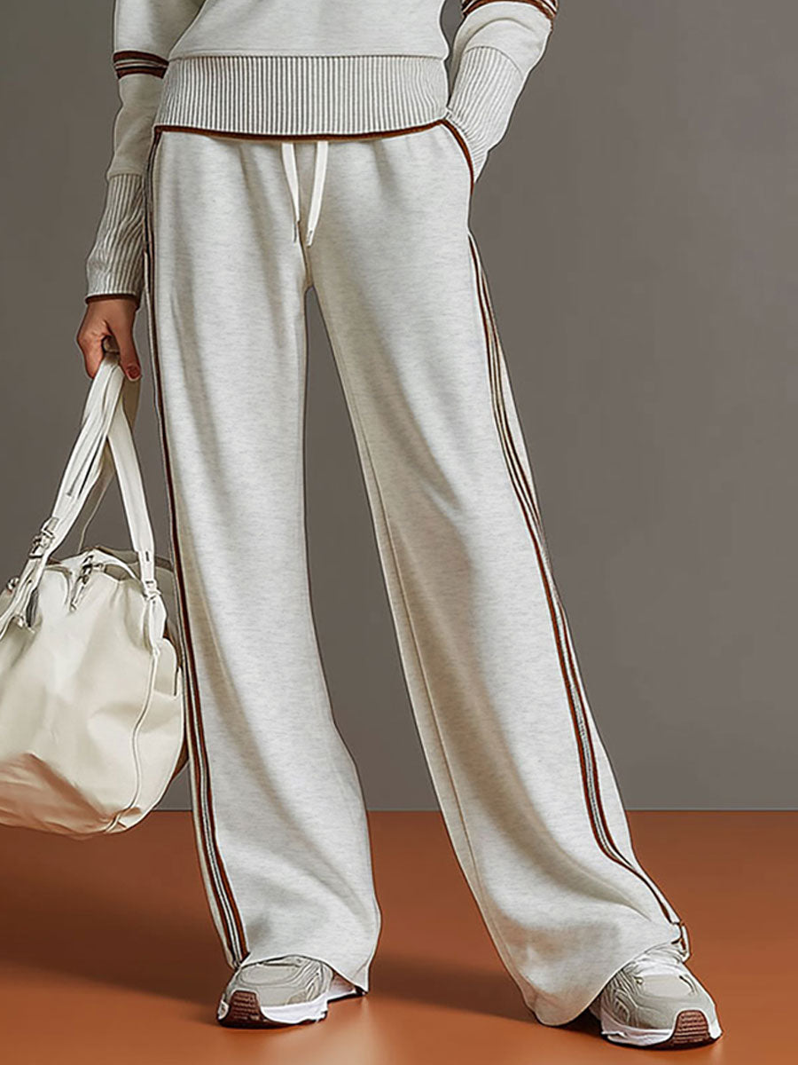 Close-up of half-zip neckline on a women's cozy sweatshirt, part of a wide-leg trouser co-ord.