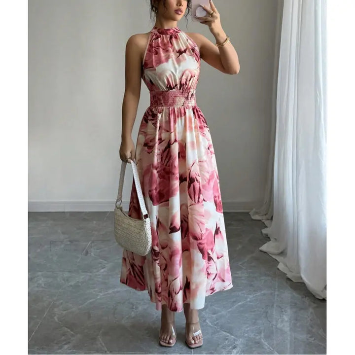 Stylish women's halter neck maxi dress with smocked waist & abstract print, great for casual outings or parties.