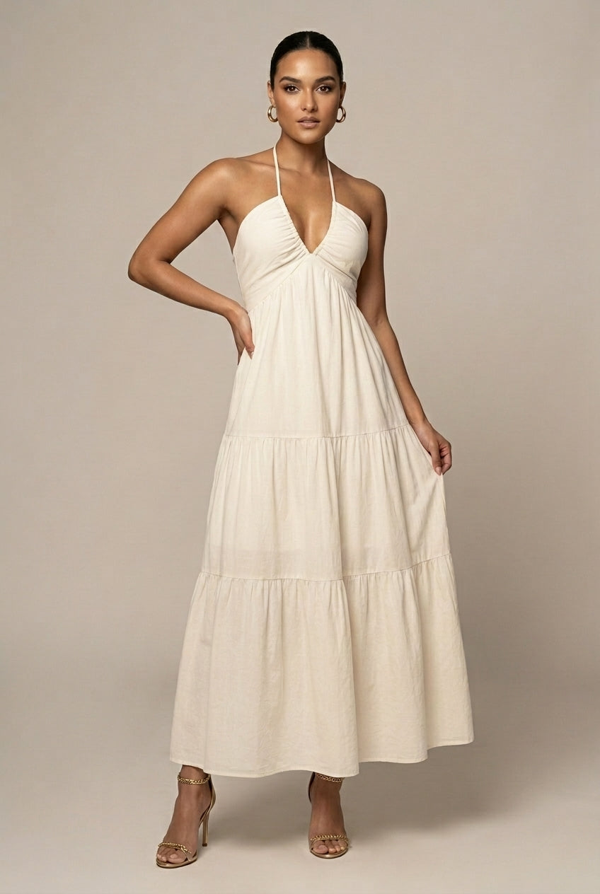 Women's halter neck maxi dress with elegant ruffle tiered skirt, perfect for summer parties.