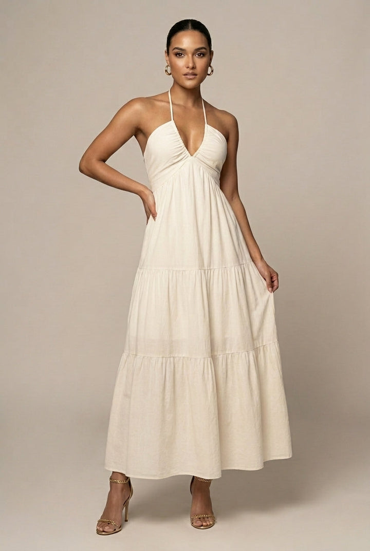 Women's halter neck maxi dress with elegant ruffle tiered skirt, perfect for summer parties.