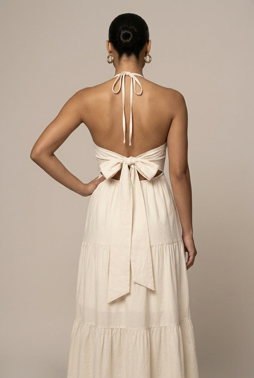 Flowy women's halter neck maxi dress featuring a beautiful tiered ruffle skirt and open back design.