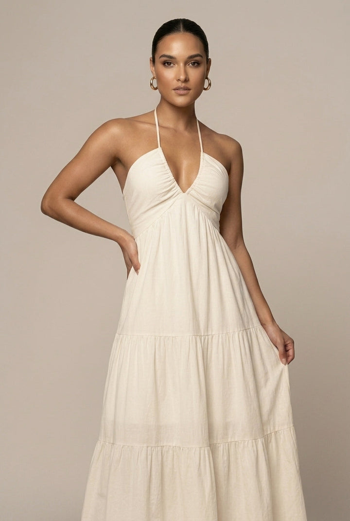 Stunning women's halter neck sundress with tie waist and cascading ruffle tiered skirt, beach ready.