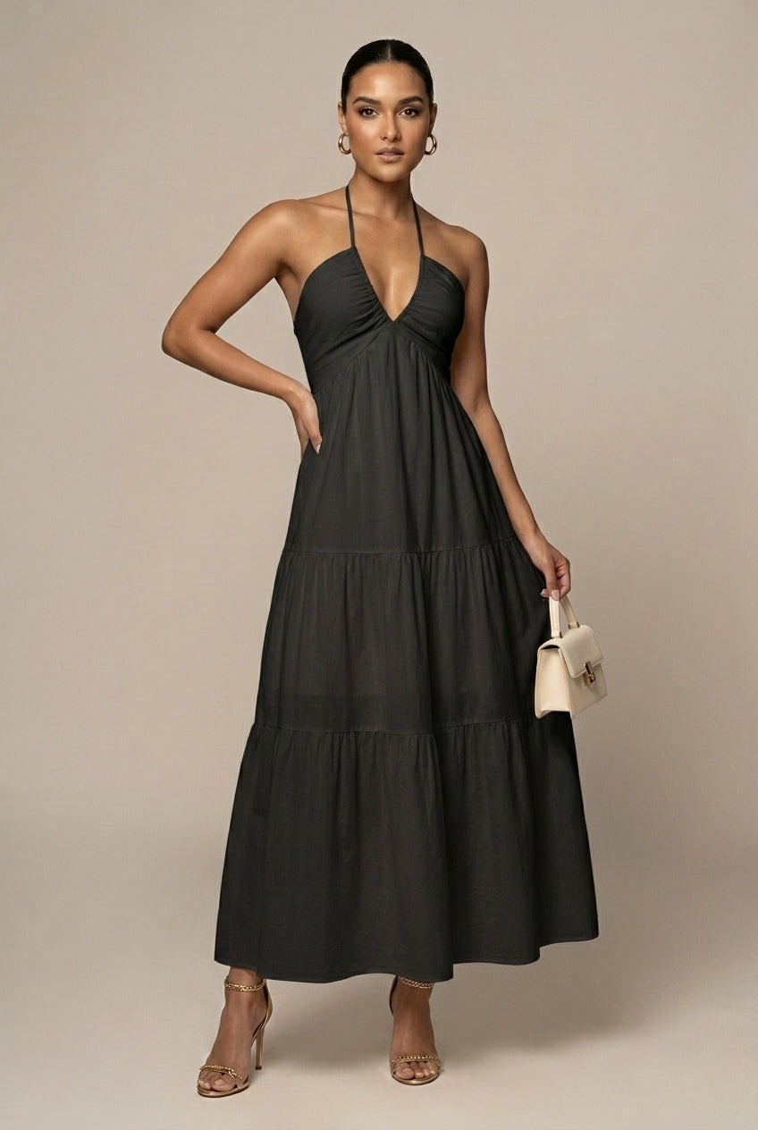 Long halter neck evening dress for women, showcasing a chic tiered ruffle skirt and open back.