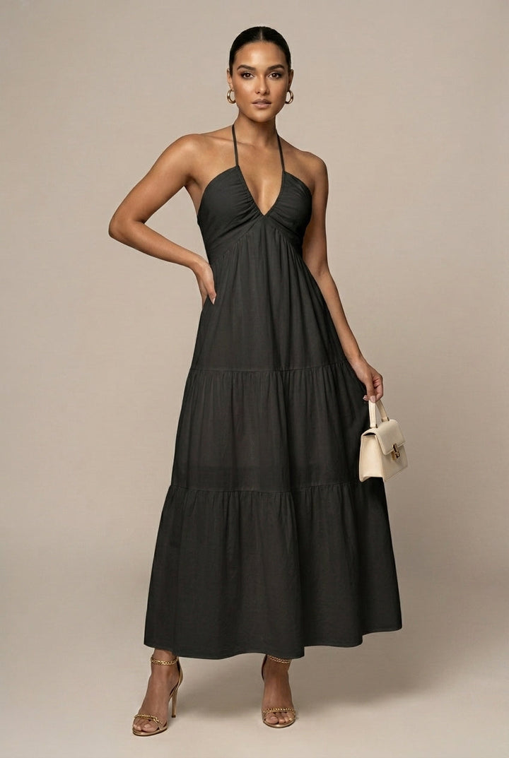 Long halter neck evening dress for women, showcasing a chic tiered ruffle skirt and open back.