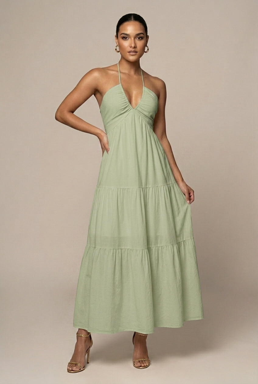 Stylish women's tiered ruffle maxi dress with halter neck & tie waist, versatile for day or night.