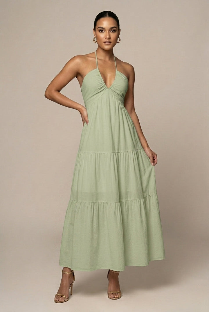 Stylish women's tiered ruffle maxi dress with halter neck & tie waist, versatile for day or night.