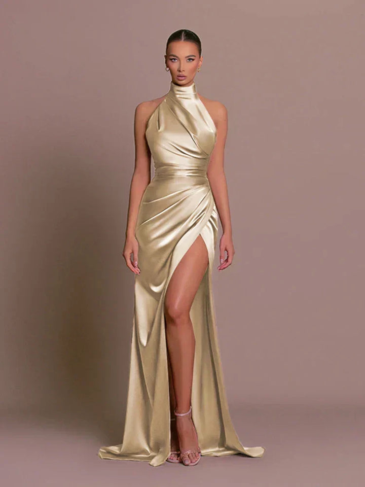 Women's halter neck maxi dress featuring ruched waist & high split. Ideal formal evening or party wear.
