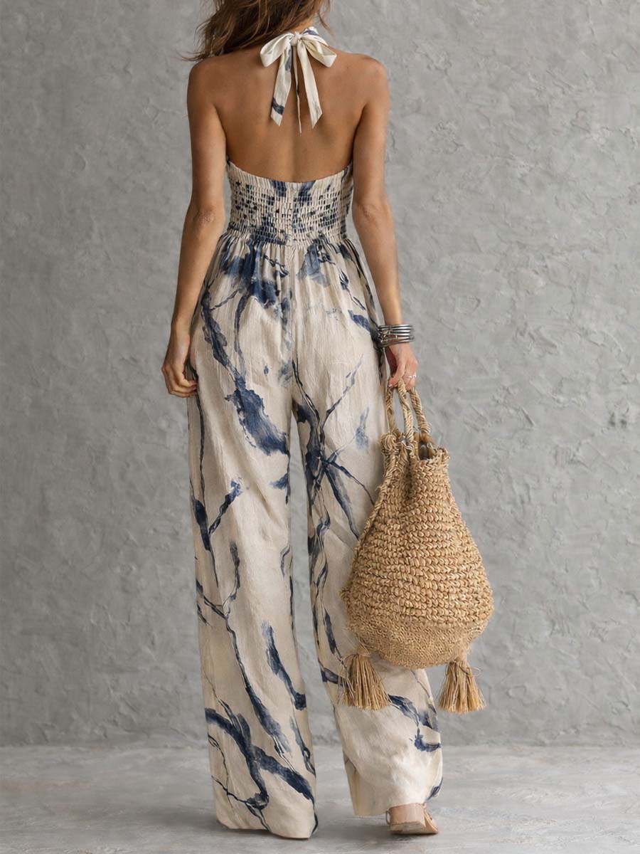 Stylish women's halter neck wide leg jumpsuit, featuring a comfortable fit & pockets for casual or party wear.