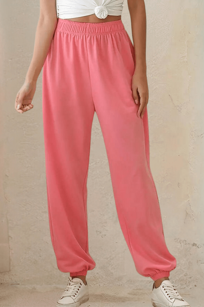 Model wearing women's high-rise joggers; relaxed fit, elastic waist, great for travel.