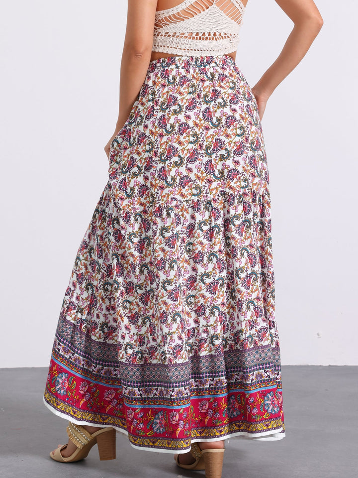 Vacation-ready high waist printed maxi skirt for women, flowing side slit for relaxation.
