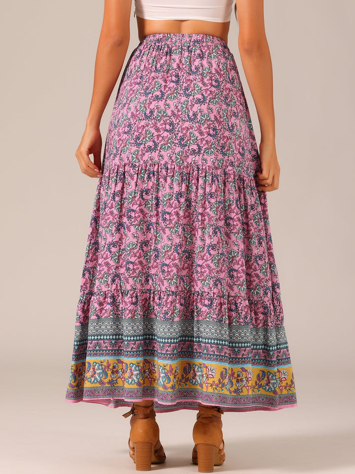 Festival-ready women's printed maxi skirt, high waist & flowing side slit for movement.