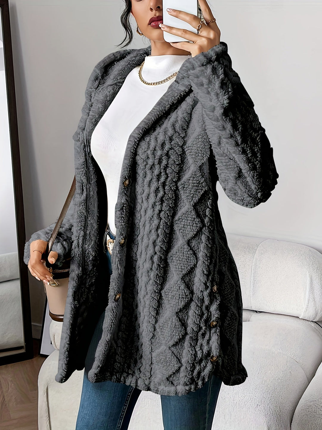 Fashionable women's winter coat, a long hooded design with prominent button accents.