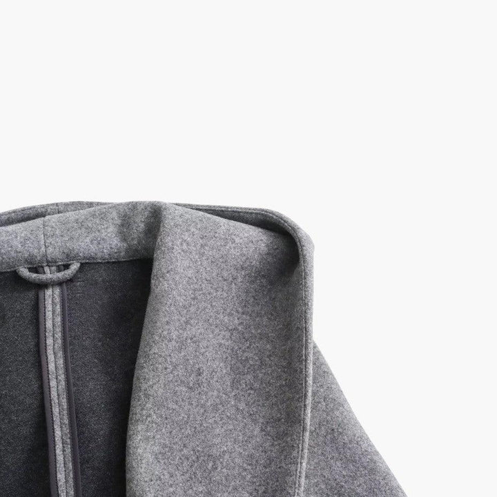 Elegant woman wearing a belted hooded trench coat, stylish all-weather long outerwear.