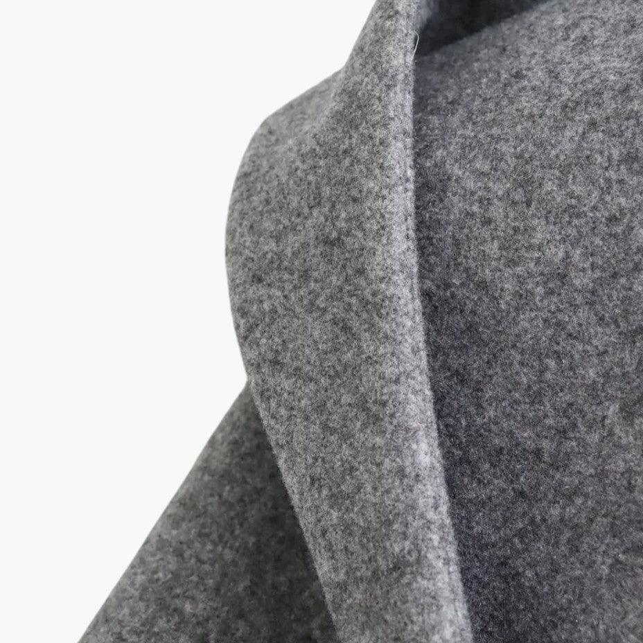 Close-up of a women's hooded trench coat collar, buttons & belt detail, classic outerwear.