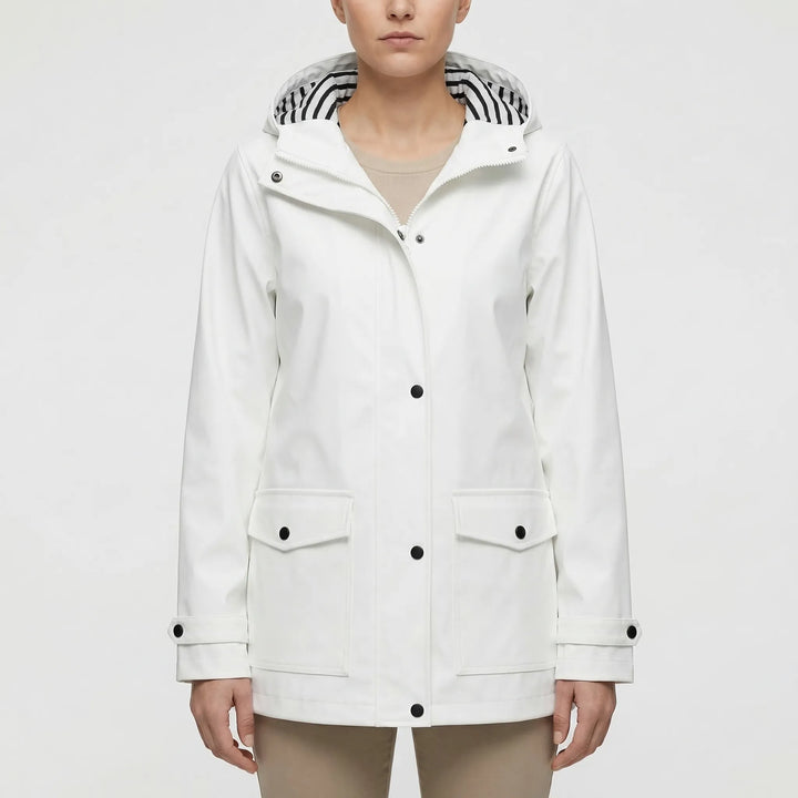 Happy woman in hooded waterproof rain jacket. Perfect lightweight outdoor gear for adventure & travel.