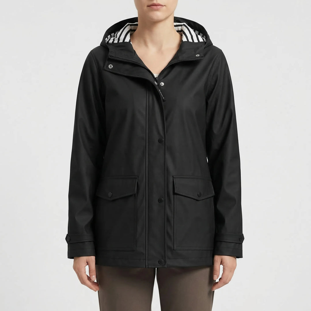 Durable women's waterproof hooded rain jacket. Lightweight, longline design for hiking & travel.