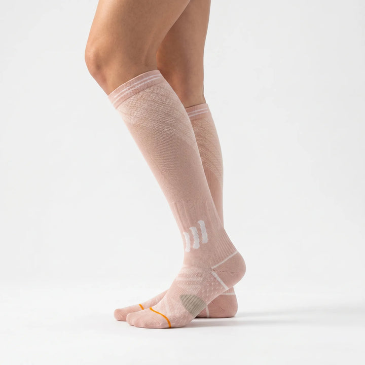 Travel-friendly women's knee-high compression socks for leg support and enhanced circulation on journeys.