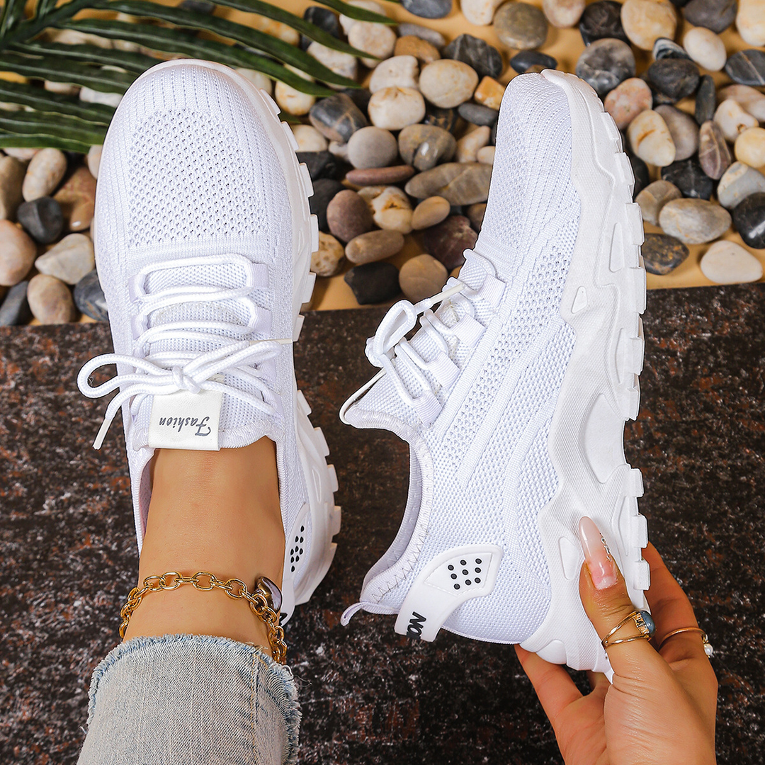 Modern women's lace-up orthopedic sneakers, combining comfort, foot support, and athletic footwear style.