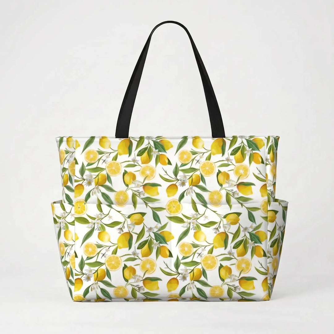 Foldable, water-resistant women's large beach tote with bright tropical lemon print, easy to pack.