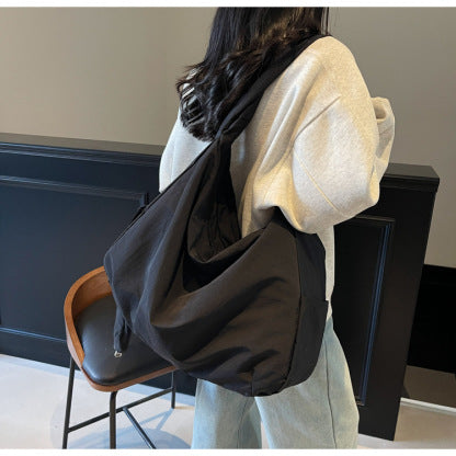 Multi-functional women's large capacity bag, convertible to shoulder or hobo style.