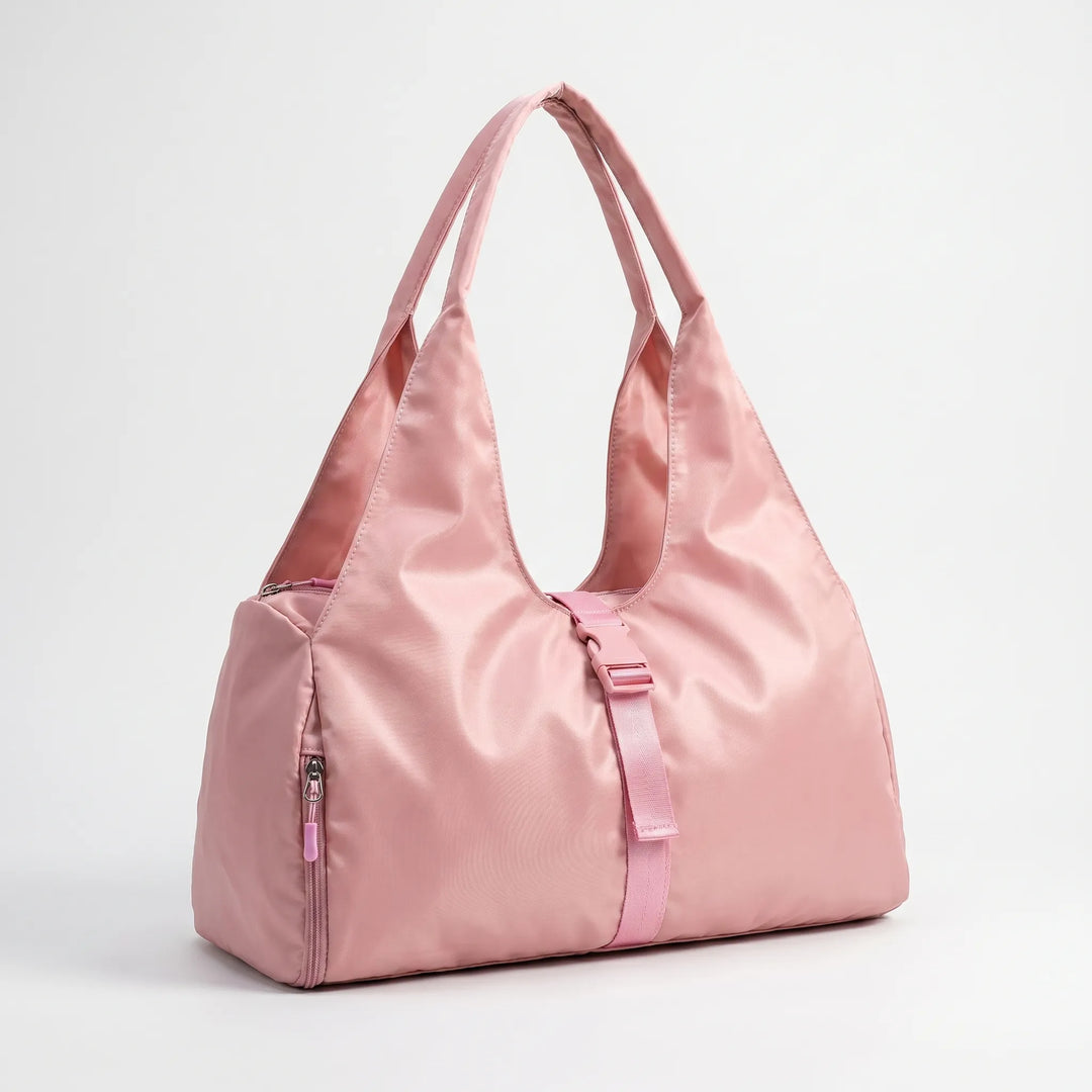 Large capacity women's fitness duffel bag with integrated shoe compartment and comfortable shoulder strap for gym or travel.