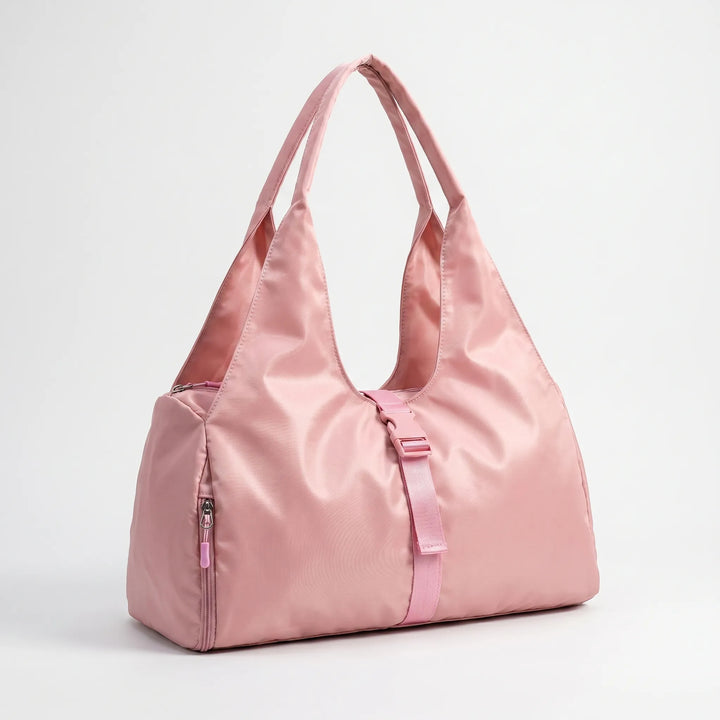 Large capacity women's fitness duffel bag with integrated shoe compartment and comfortable shoulder strap for gym or travel.
