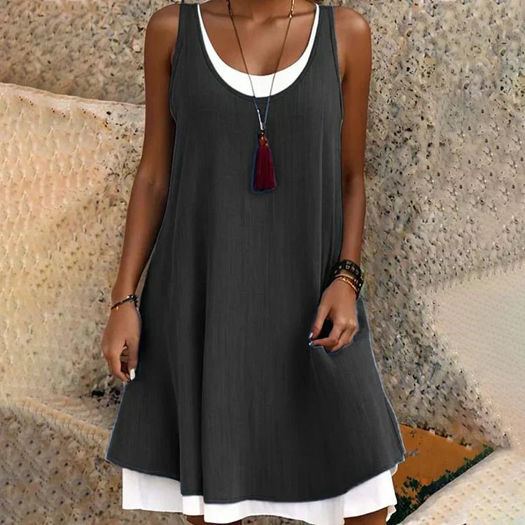 Women's layered mini dress, sleeveless scoop neck. Chic A-line swing style, versatile for summer casual fashion.