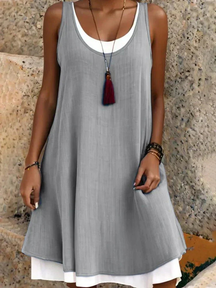 Chic women's layered mini dress with a scoop neck and sleeveless design. Perfect versatile summer fashion.
