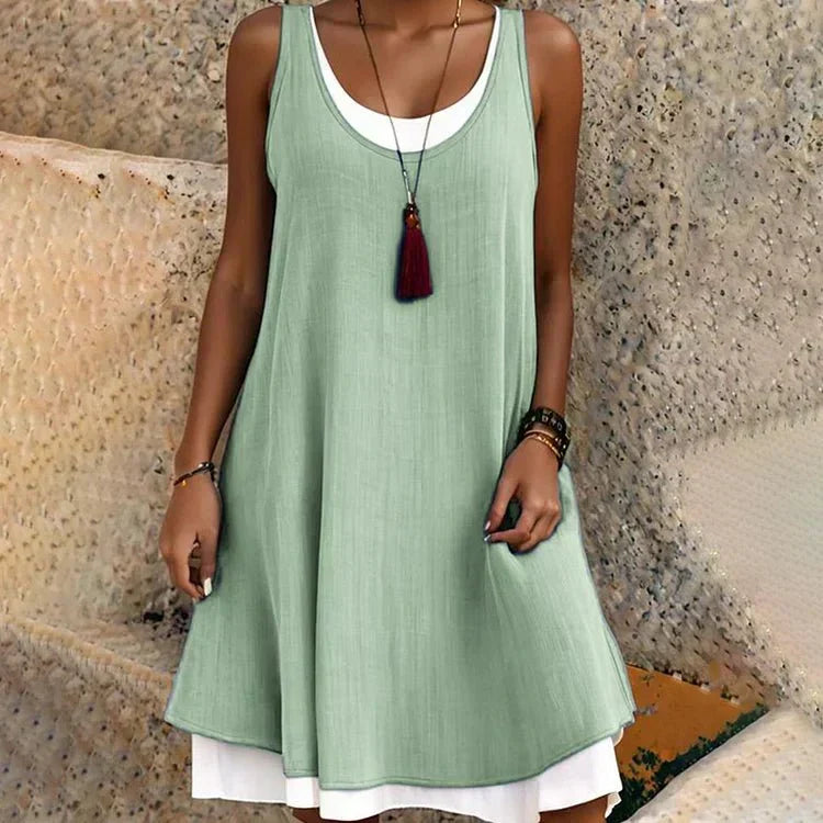 Fashionable women's layered mini dress, A-line swing, sleeveless scoop neck. Ideal for summer casual wear.