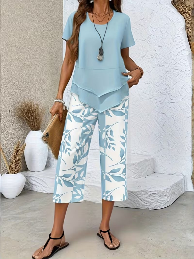Stylish women's leaf print two-piece set featuring a relaxed fit top & cropped pants, perfect for vacation.