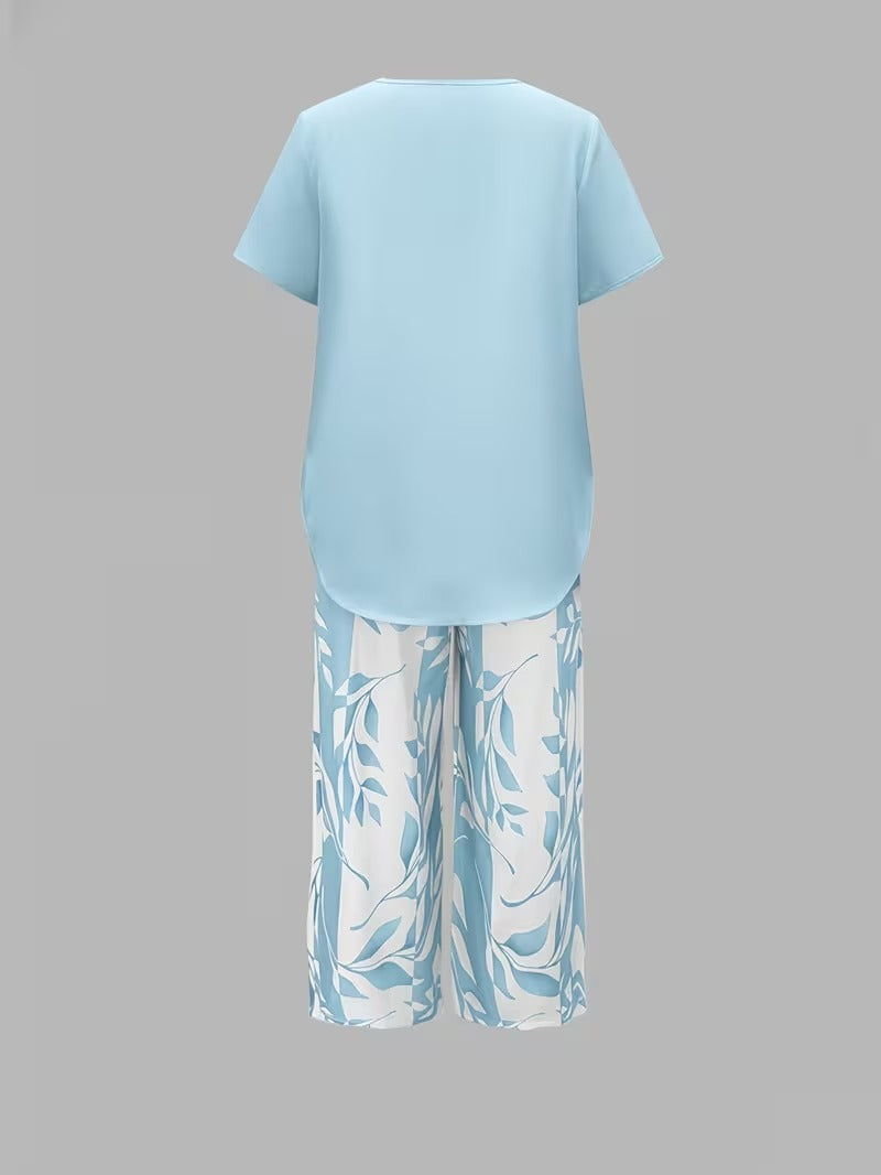 Trendy women's leaf print summer fashion 2-piece set with a relaxed short sleeve top and cropped pants.