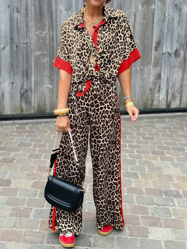 Women's leopard print wide-leg jumpsuit with V-neck, short sleeves, and relaxed fit.