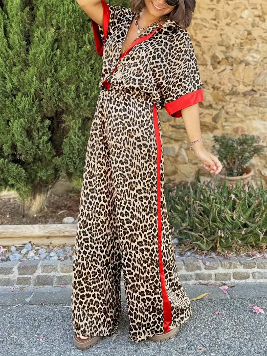 Stylish women's V-neck leopard print wide-leg jumpsuit, perfect for summer fashion.