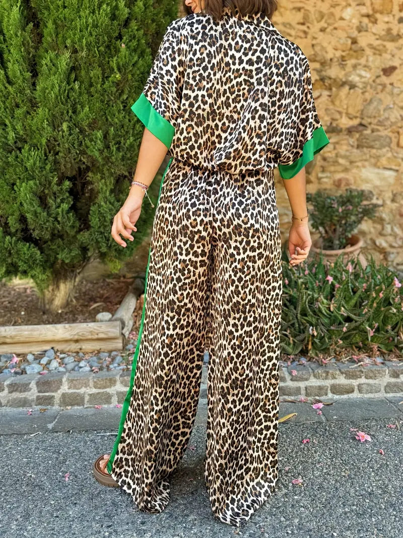 Trendy women's animal print wide-leg jumpsuit, designed with a V-neck and short sleeves.