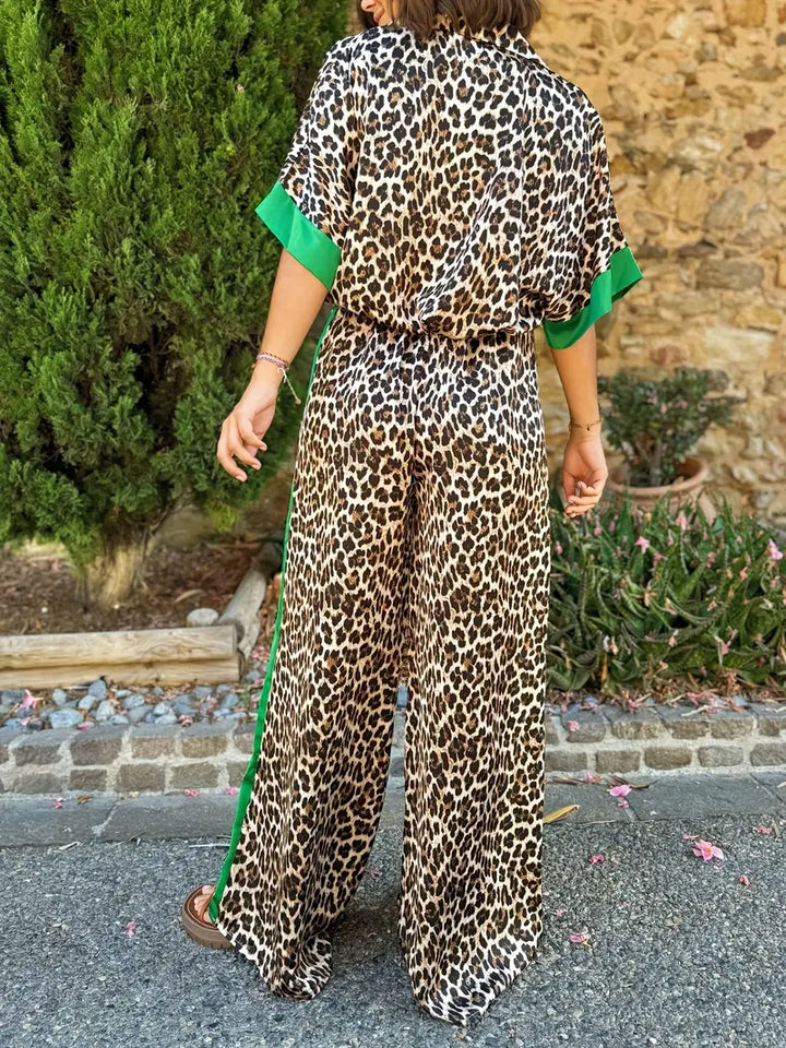 Trendy women's animal print wide-leg jumpsuit, designed with a V-neck and short sleeves.