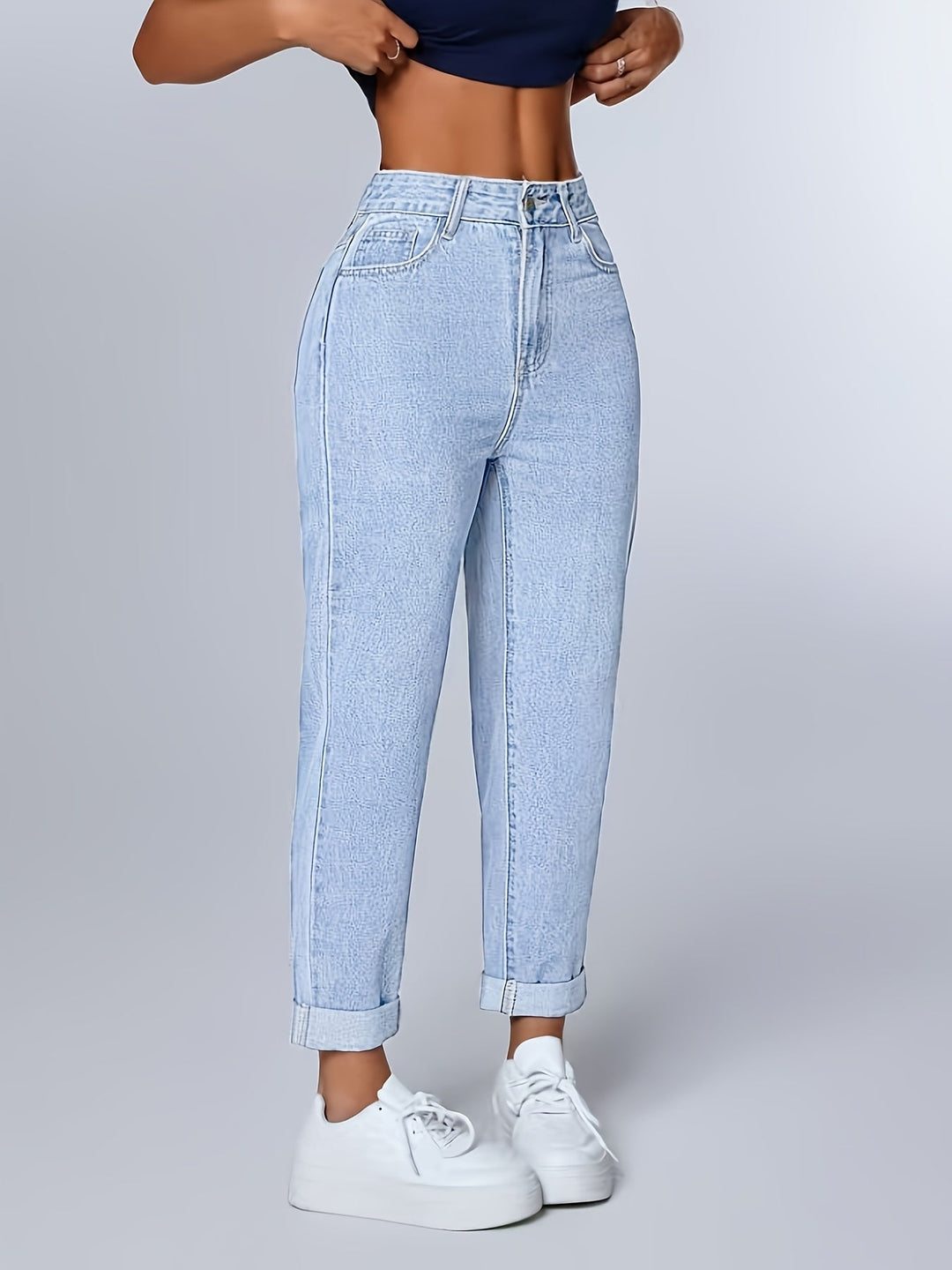 Women's light wash high waist mom jeans with a relaxed fit. Tapered leg and cuffed hem, great for casual wear.