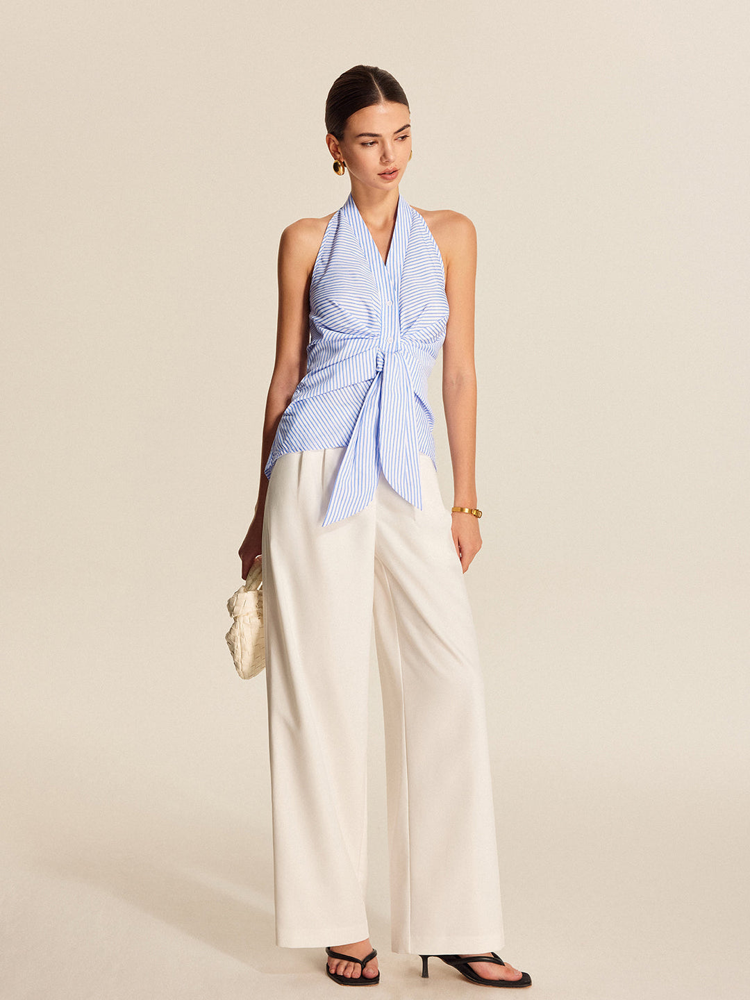 Sleeveless striped halter top for women with a chic tie-front. Perfect for professional office or casual daily wear.