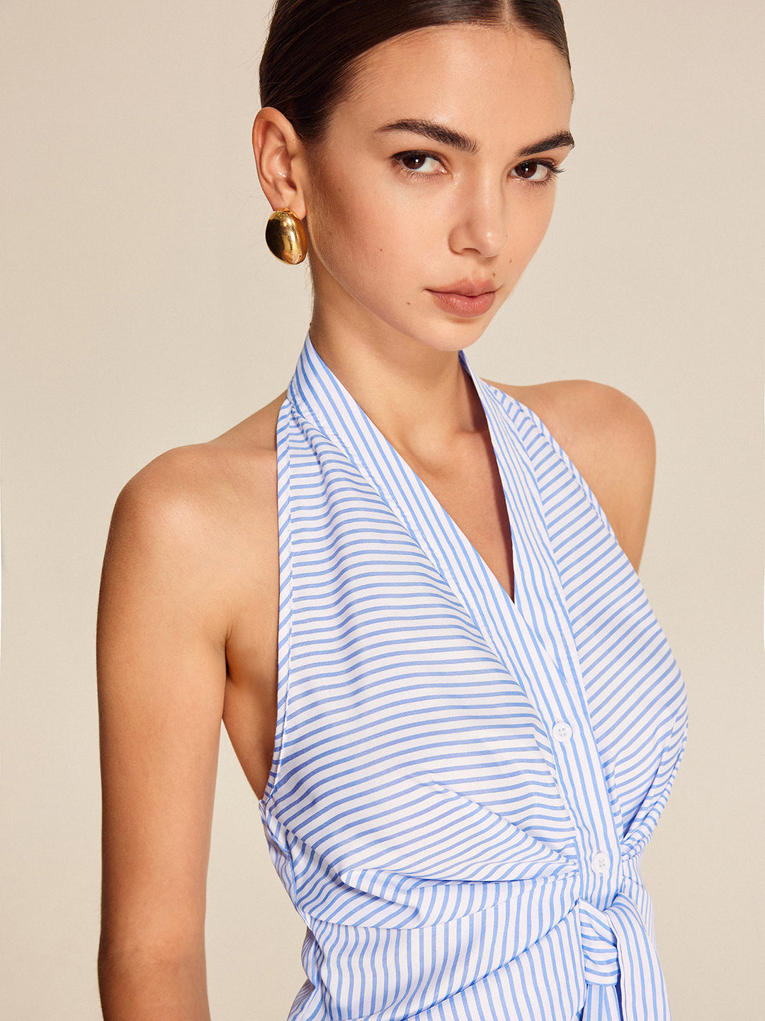 Stylish women's sleeveless striped halter top with a fashionable tie-front. Great for professional & daily outfits.